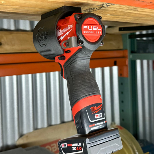 Milwaukee cordless power tool secured in the MGS-081 Holster by Metalgear Engineering—a rugged, 3D-printed tool holster designed for reliable mounting on walls, workbenches, or 80/20 framing in workshop and industrial environments.