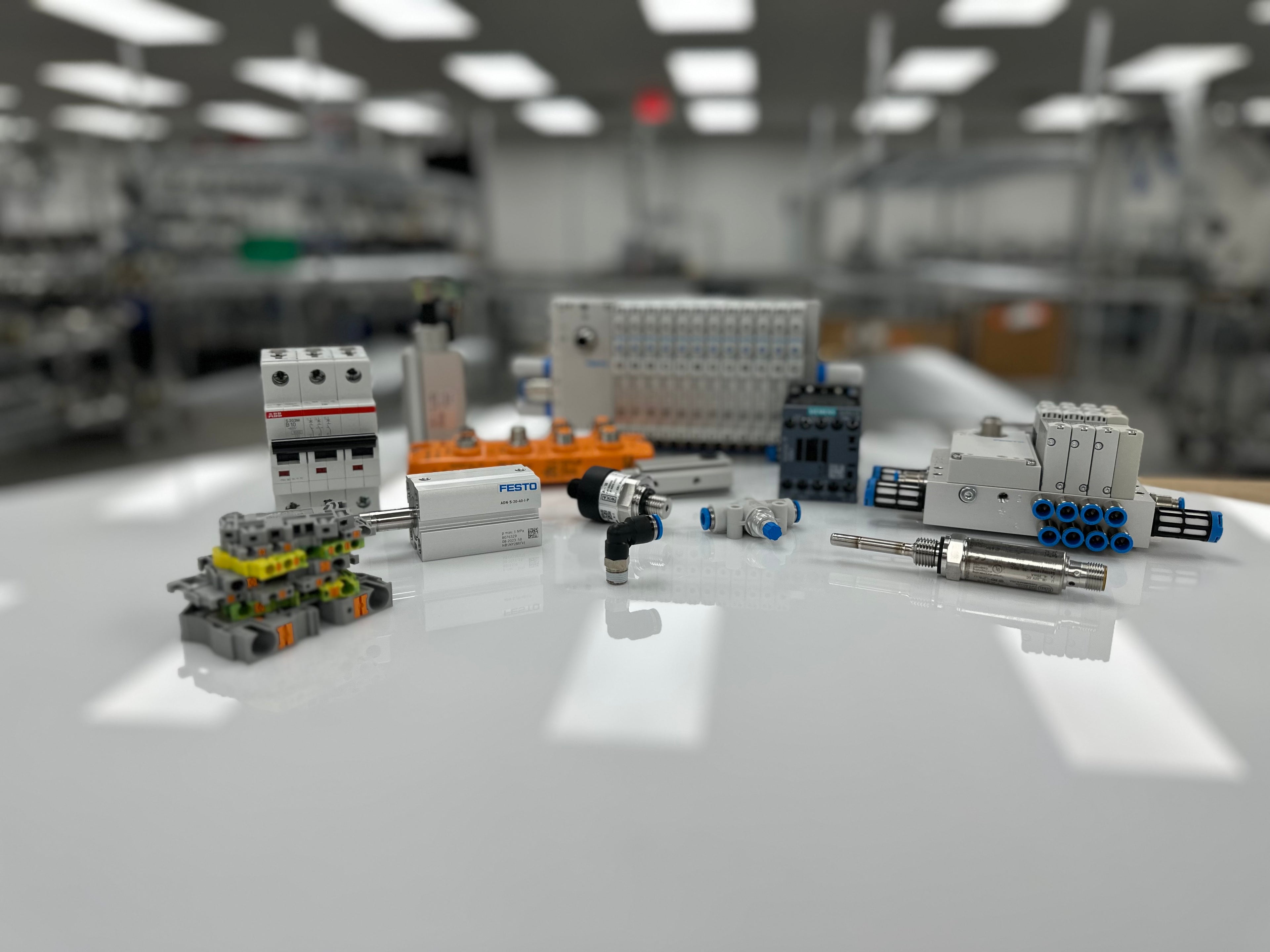 Automation and pneumatic components from Metalgear Engineering, featuring Festo cylinders, valves, terminal blocks, circuit breakers, and fittings displayed on a white surface.