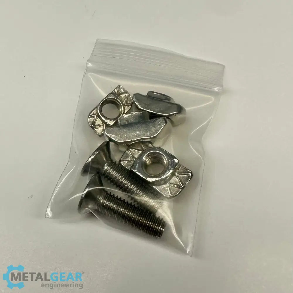 A small clear plastic bag containing stainless steel T-slot nuts and countersunk screws, typically used in aluminum extrusion systems, provided by Metalgear Engineering.