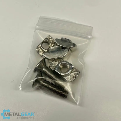 A small clear plastic bag containing stainless steel T-slot nuts and countersunk screws, typically used in aluminum extrusion systems, provided by Metalgear Engineering.